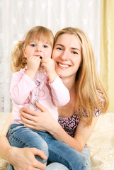 mother and little girl on her knees