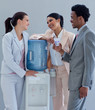 © WavebreakMediaMicro - Business people speaking next to a water cooler