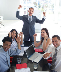 Business team in a meeting celebrating a success