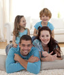 © WavebreakMediaMicro - Parents, daughter and son on floor in living-room