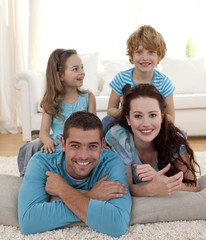 Wall Mural - Parents, daughter and son on floor in living-room