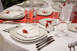 Table setting with plates and silverware (in red and white)