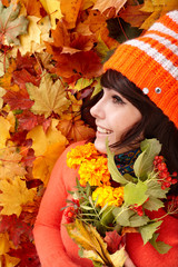 Wall Mural - girl in autumn orange hat, leaf group, flower. outdoor.