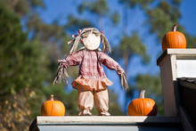 Scarecrow Decoration And Pumpkins On The Roof