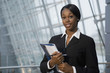 © Mark Edward Atkinson/Blend Images - African businesswoman holding paperwork