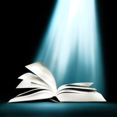 Opened book with bright light beam