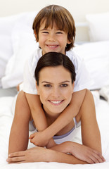 Son hugging his mother in bed