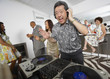 © Trevor Lush/Blend Images - Asian DJ performing at party