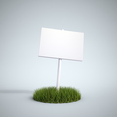 an empty sign on a patch of grass