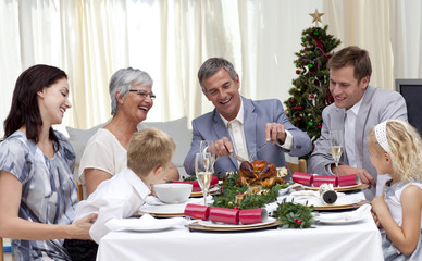 Wall Mural - Family eating turkey in Christmas Eve