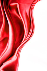 Red silk fabric texture on white background. Copy space