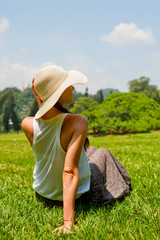 Wall Mural - young woman resting in the park