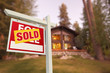 Sold Home For Sale Sign and Beautiful Log Cabin