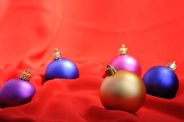 Colored Christmas balls on red background