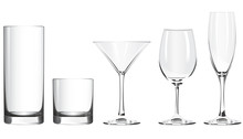 Various Glass Goblets Stand On A White Background