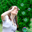 © Vladitto - smile teen blowing soap bubbles