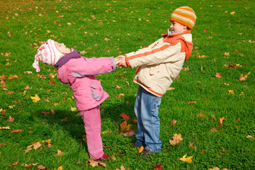 Brother and sister playing in the park