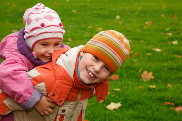 Brother and sister walk in the park