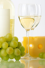 Bottle of white wine, wine glasses, grape and cheese