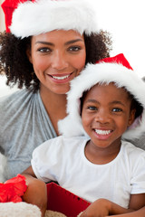 Wall Mural - Portrait of a mother and a daughter wearing a Christmas hat