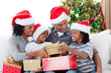 Wall Mural - Afro-American family holding Christmas gifts