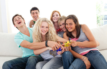 Teenagers playing video games in the living-room