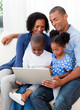 © WavebreakMediaMicro - Happy family using a laptop