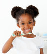 © WavebreakMediaMicro - Portrait of an Afro-american girl brushing her teeth