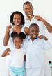 © WavebreakMediaMicro - Smiling family brushing their teeth