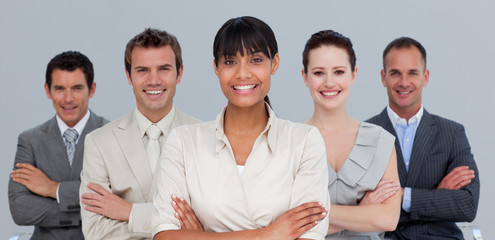 Wall Mural - Smiling multi-ethnic business team with folded arms