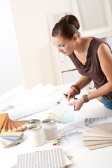 Wall Mural - Young female designer working with color swatches