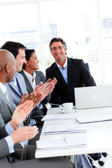 Team of successful business people clapping