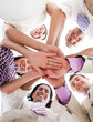 © WavebreakMediaMicro - International business people holding hands together