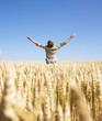 Man in Wheat Field with Arms Outstretched