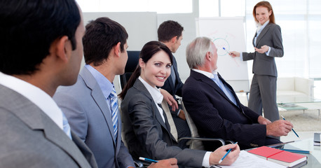 Wall Mural - Businesswoman reporting sales figures to her team