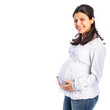 Young pregnant woman holding her stomach smiling