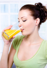 Attractive Woman drinking fresh orange juice