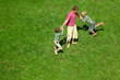© Pavel Losevsky - Two boys play with the adult a lawn. The top view.