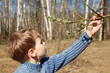 © Pavel Losevsky - The boy looks at full bud in spring park