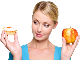 woman choose  from sweet cake and red apple