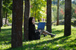 © MNStudio - Young lady with a notebook in a park