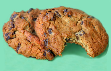 Two chocolate chip cookies, one already bitten