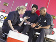 © Monkey Business - Three paramedics chatting and doing paperwork