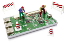 Miniature Toy Workers Repairing Computer Part With Circuit