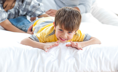 Wall Mural - Adorable little boy playing with his parents