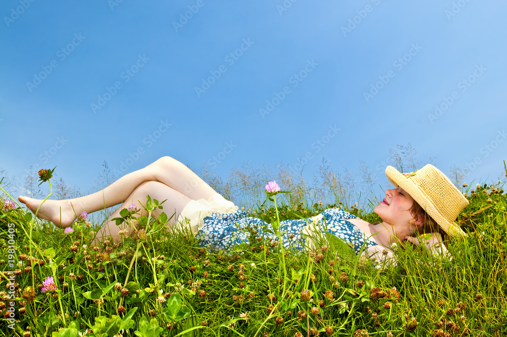Young girl laying in meadow