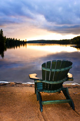 Wall Mural - Wooden chair at sunset on beach