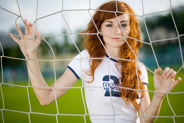 healthy beautiful girl with freckles on soccer field