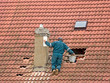© milkovasa - worker on the roof chimney repairs