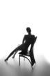 © Netfalls - Silhouette of a beautiful young woman sitting
